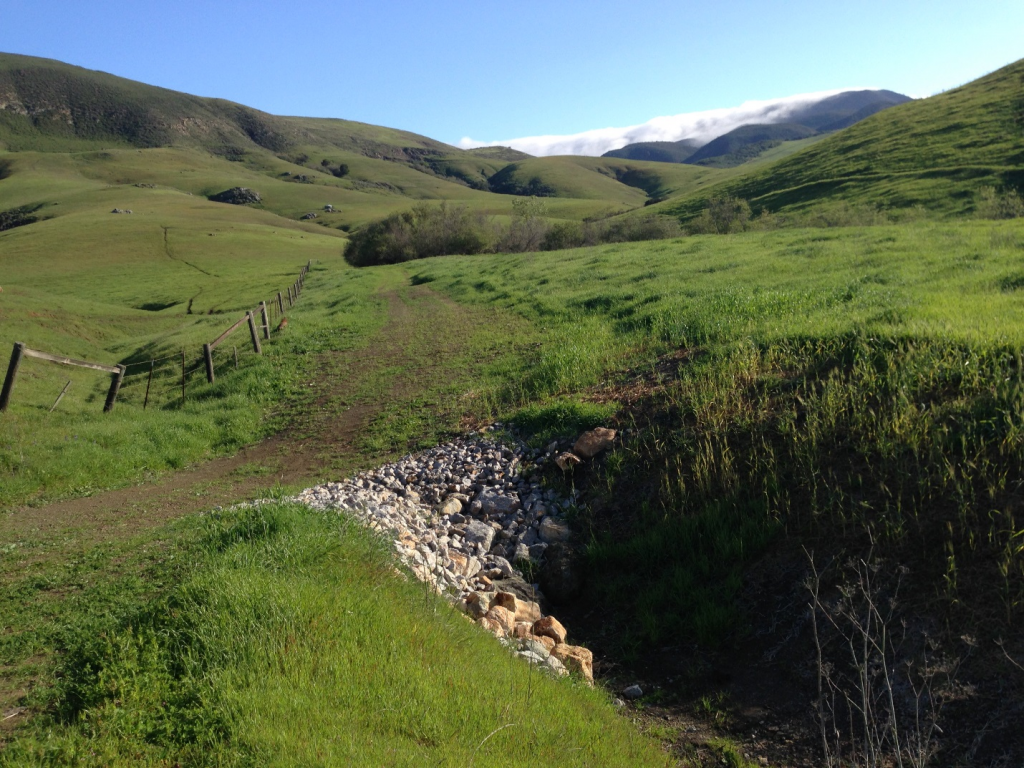 Our rural road restoration project addressed 58 sites on more than 11 miles of road. The road above, located on Camp San Luis Obispo, was eroding and at risk of becoming impassable before this project. We added the large rocks along the side of the road to stabilize it, reduce erosion, and to help slow and direct water off its surface during storms.