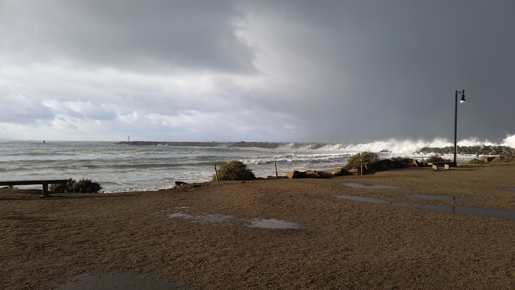 Salty ocean water enters the bay through the harbor mouth. During big storms, like the one pictured above, waves can even wash over the jetty. 