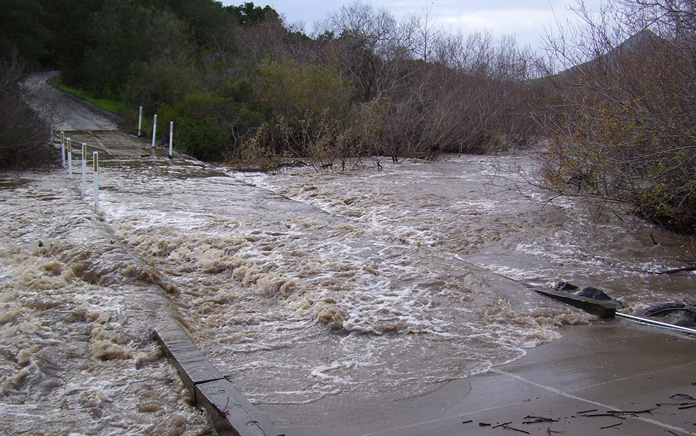 In this photograph from 2019, heavy rains caused Chorro Creek to top the bridge at Canet Road. With climate change, we expect that the Morro Bay area will receive less overall precipitation and that the storms we do experience will be more intense.
