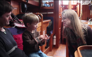 Kaila Dettman, Terry Hooker, and their son examine a crab