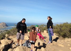 A group of girl scouts and their parents look out over the estuary from the top of Black Hill.