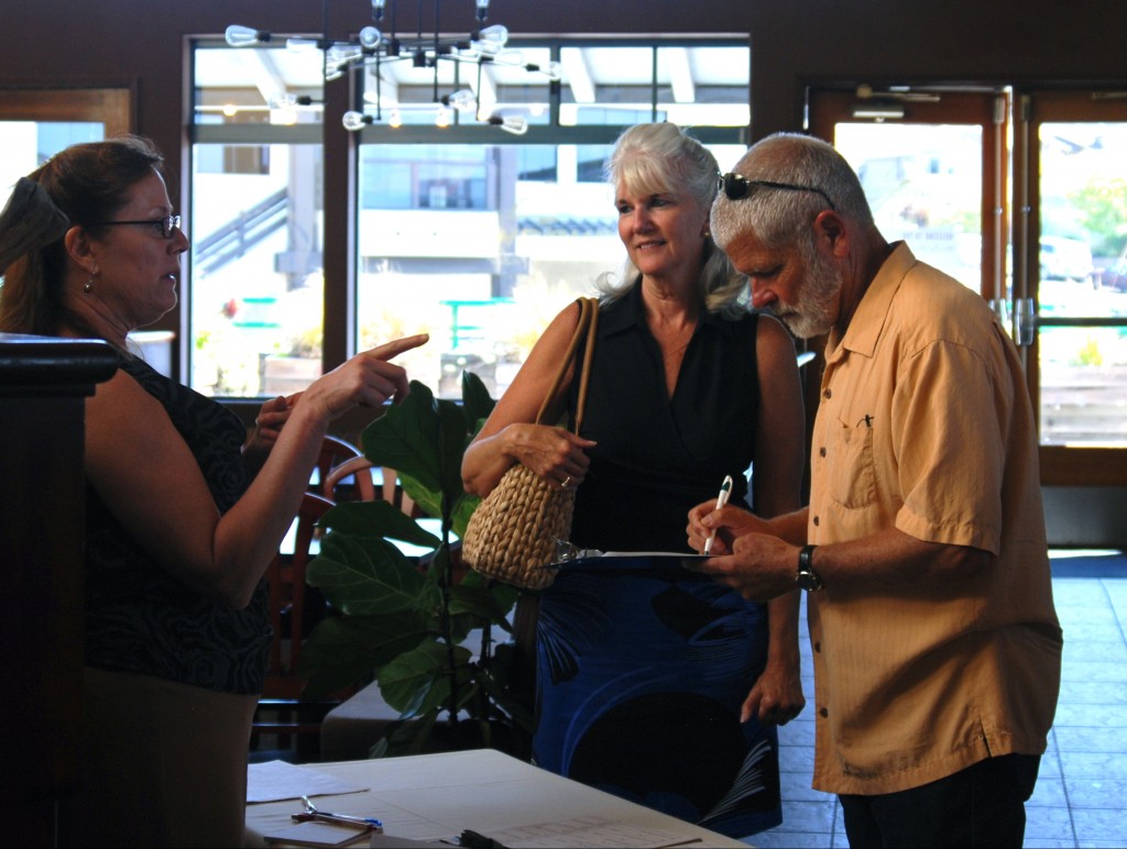 Bruce Gibson, District Two Supervisor for the County of San Luis Obispo signs the guest book. Legislative Assistant Cherie McKee and Estuary Program Office Manager, Cynthia Milhelm, discuss the event.