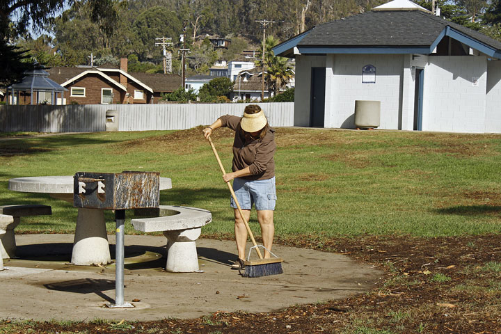 Club member Jean sweeps a picnic area clean. Photograph courtesy of Ruth Ann Angus.