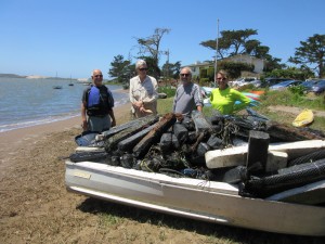 5 volunteers spent 15 total hours skimming, hauling, and pulling trash from the shoreline of the Elfin Forest by boat. They event pulled this skiff out of the water!