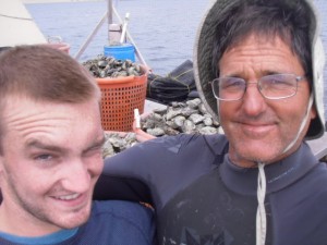 George Trevelyan (right), Community Volunteer of the Year, and his nephew, John (left), working on the Grassy Bar Oyster Company farm.