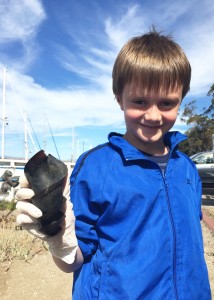Volunteer River Ciao Flynn holds the horn shark egg case he found during our shoreline cleanup.