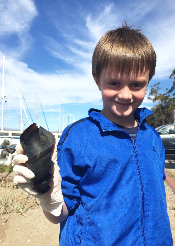 Volunteer River Ciao Flynn holds the horn shark egg case he found during our shoreline cleanup. 