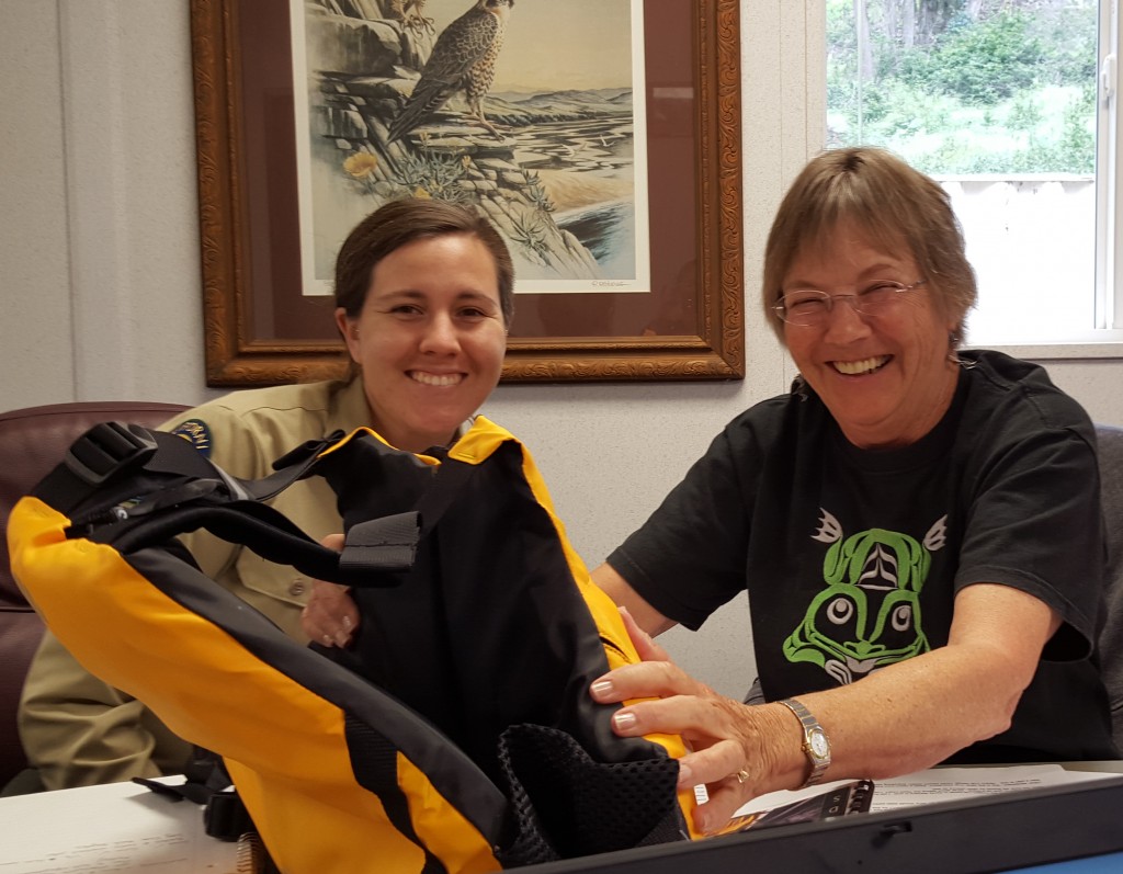 Jenny and Bette, two of the members of the team who created and implemented the SeaLife Stewards program check out one of their new life vests. 