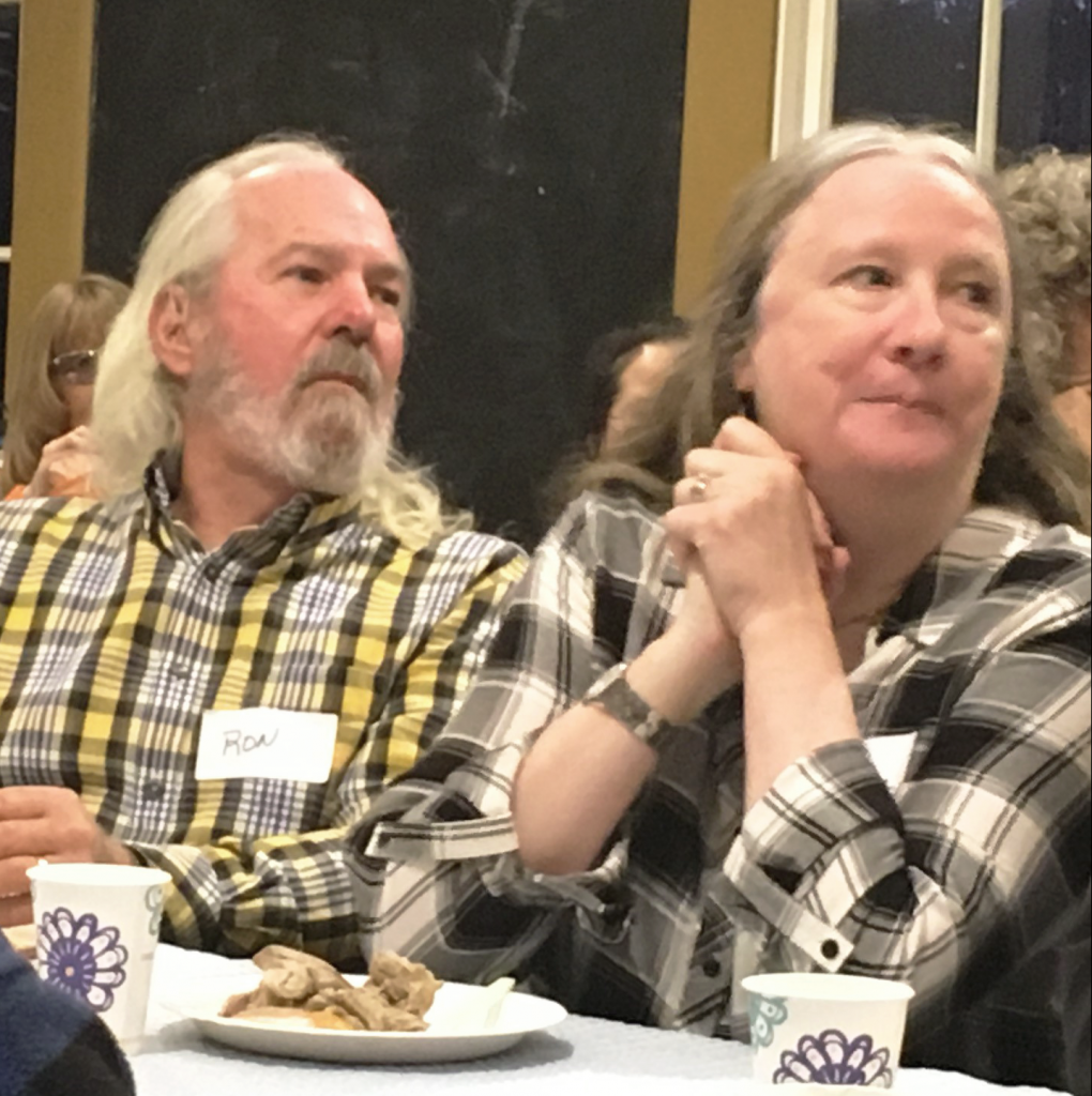 Ron Ruppert, on left, listens to Executive Director welcome volunteers to our appreciation event. 