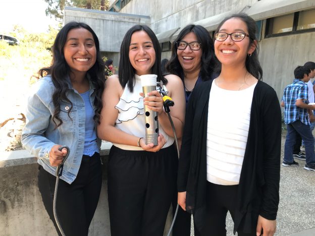 Students pose with their finished prototype during the post-presentation reception.