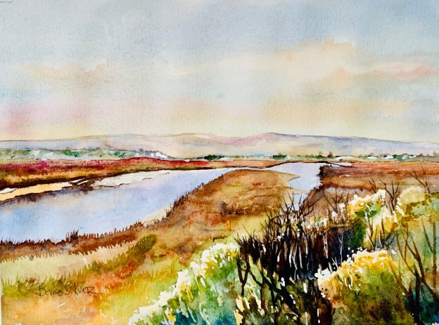 Bernie Kurtz's painting, Morro Bay Estuary, was inspired by the view of the sun reflecting off the water and backlighting the brush. She painted it at the corner of Main St. and South Bay Boulevard in Morro Bay.