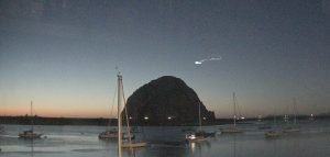 A noctilucent cloud hangs in the sky over Morro Rock