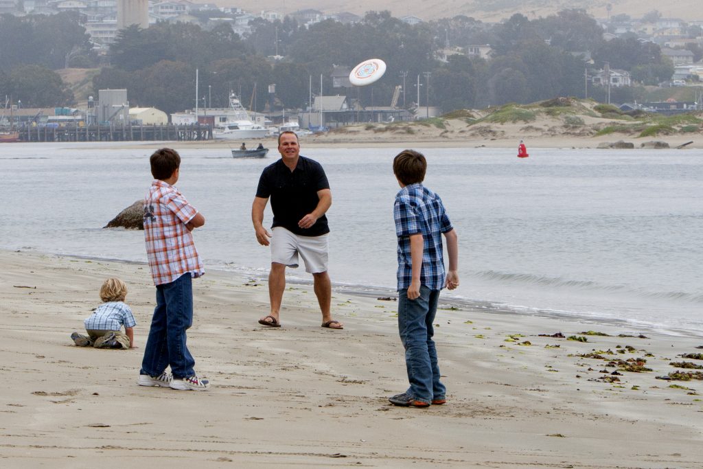A family plays frisbee at the beach along the estuary. Photograph courtesy of Matt Corning.