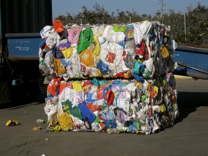 Plastic waste is compacted and bound together for transport.