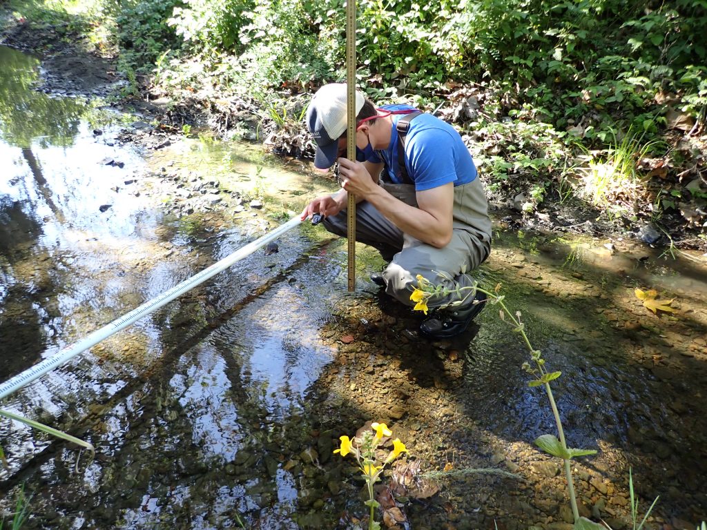 Estuary Program field technician, Blake Toney, measures pebble sizes as a part of the 2020 Bioassessment effort on Upper Los Osos Creek. 