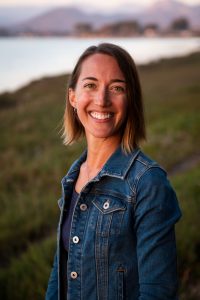 Morro Bay National Estuary Program Executive Director, Lexie Bell, stands in front of the salt marsh in Morro Bay.