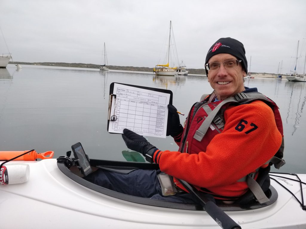 Mike, a Dawn Patrol volunteer, records dissolved oxygen measurements while sampling in the Front Bay.