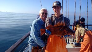 Nick and local fisherman with a Copper Rockfish on a boat