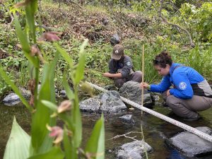 Corpsmembers measuring stream flow in a SLO County creek.