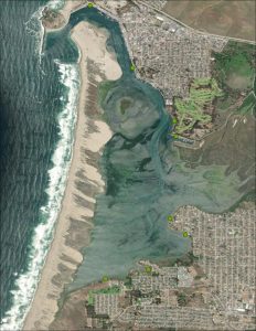 An aerial map of the Morro Bay estuary and surrounding area. There are eight green dots around the edge of the estuary.